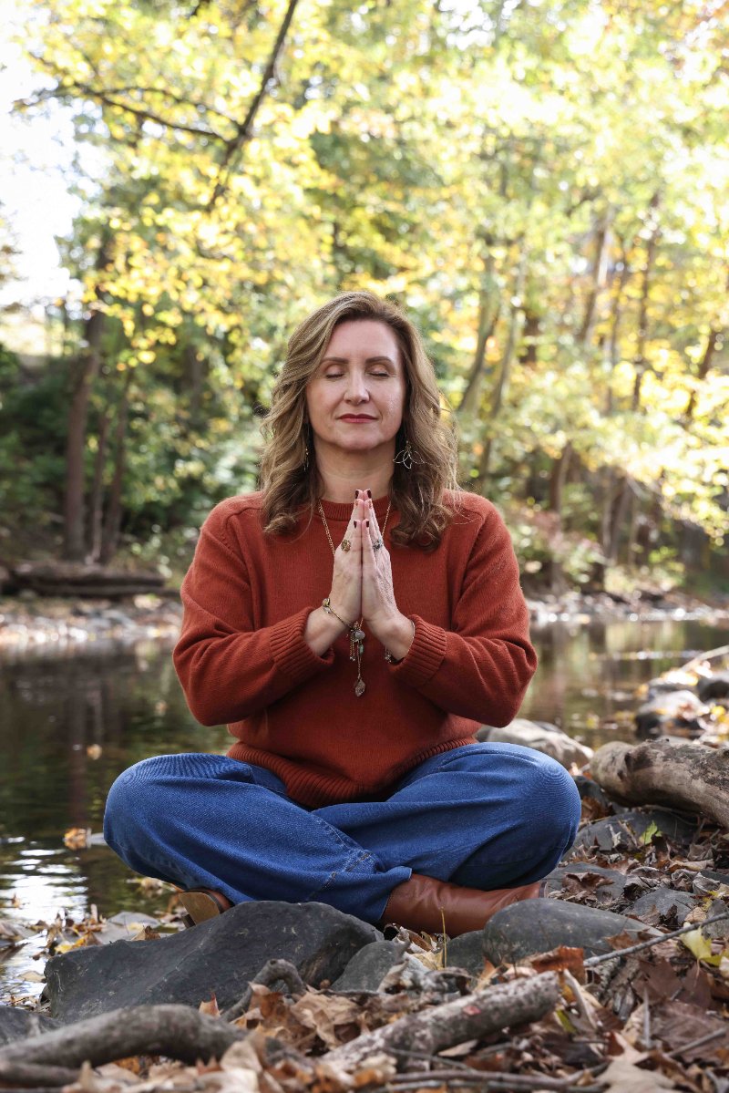 Christine Dorsey in a woodland setting during a remote pet energy healing session